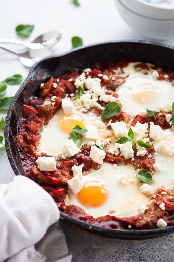 Cast iron pan with Shakshuka and poached eggs